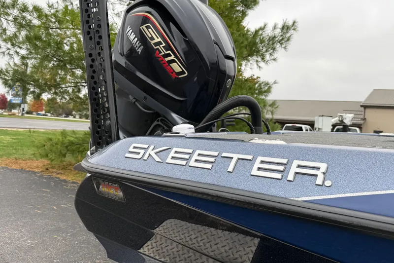Slide: The Image of 2022 Skeeter ZXR21 boat with Yamaha SHO engine, parked outdoors. - 12