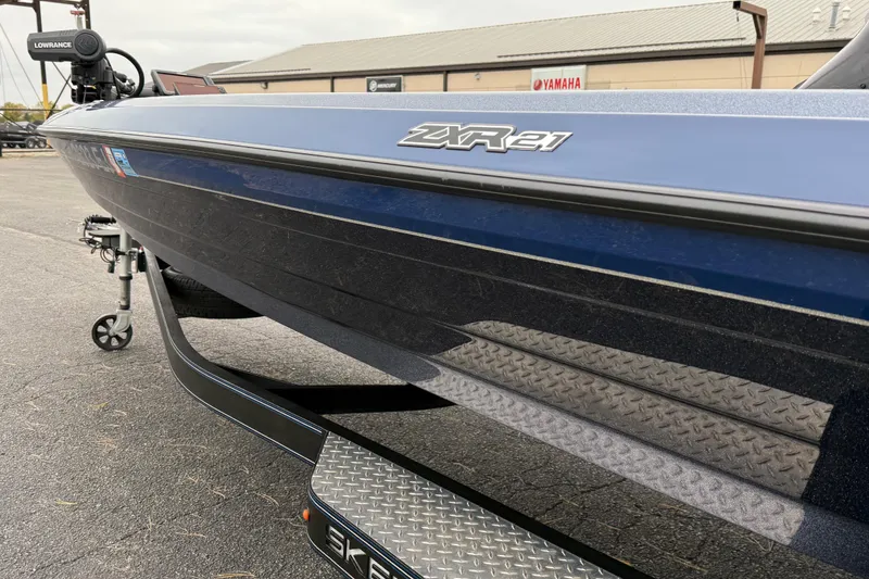 Slide: The Image of 2022 Skeeter ZXR21 boat, blue exterior, parked with visible Lowrance equipment. - 15