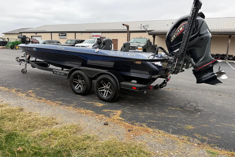 Slide: The Image of 2022 Skeeter ZXR21 boat on trailer, parked outdoors near dealership. - 3