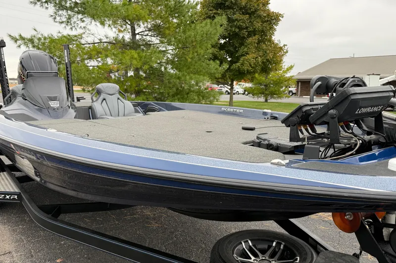 Slide: The Image of 2022 Skeeter ZXR21 fishing boat with Lowrance electronics, parked outdoors. - 7