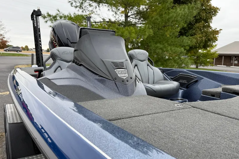 Slide: The Image of 2022 Skeeter ZXR21 boat with sleek design and comfortable seating, parked outdoors. - 9