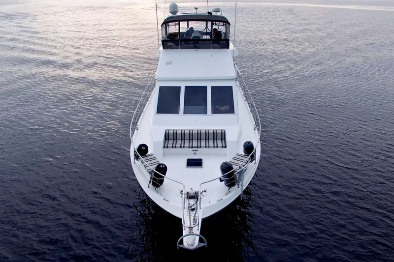 Slide: The Image of 1988 Viking 63 Cockpit Motor Yacht on calm water, aerial view. - 10