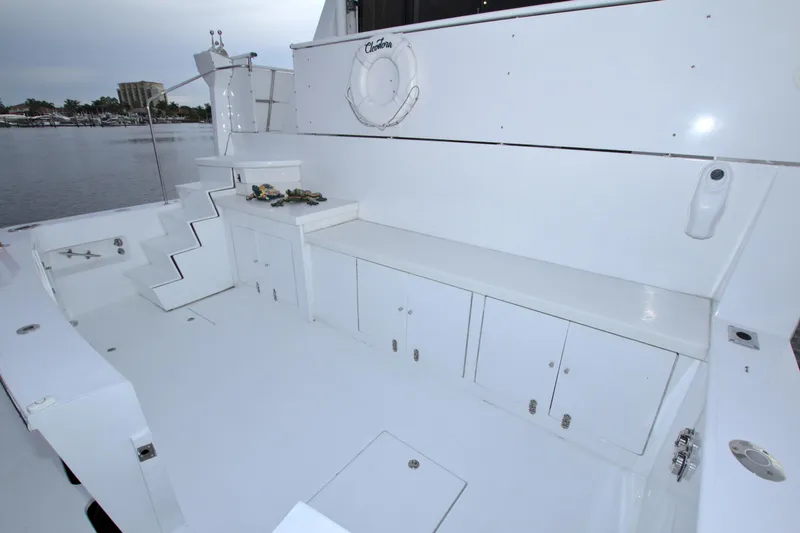 Slide: The Image of 1988 Viking 63 Cockpit Motor Yacht, spacious white deck with storage cabinets. - 16