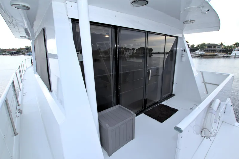 Slide: The Image of 1988 Viking 63 Cockpit Motor Yacht deck with sliding glass doors. - 18