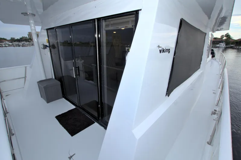 Slide: The Image of 1988 Viking 63 Cockpit Motor Yacht with sliding glass doors and spacious deck. - 19