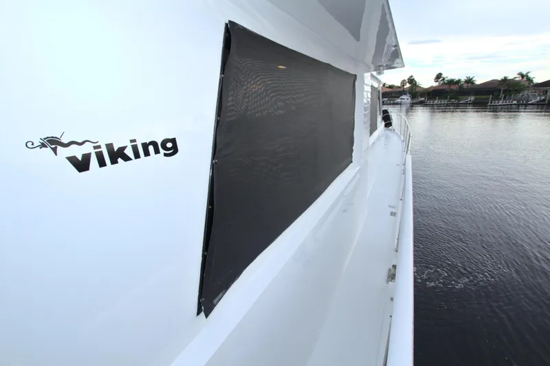 Slide: The Image of 1988 Viking 63 Cockpit Motor Yacht side view on water. - 21