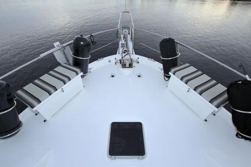 Slide: The Image of Bow view of 1988 Viking 63 Cockpit Motor Yacht on calm water. - 24