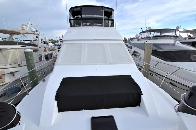 Slide: The Image of 1988 Viking 63 Cockpit Motor Yacht docked at a marina. - 27