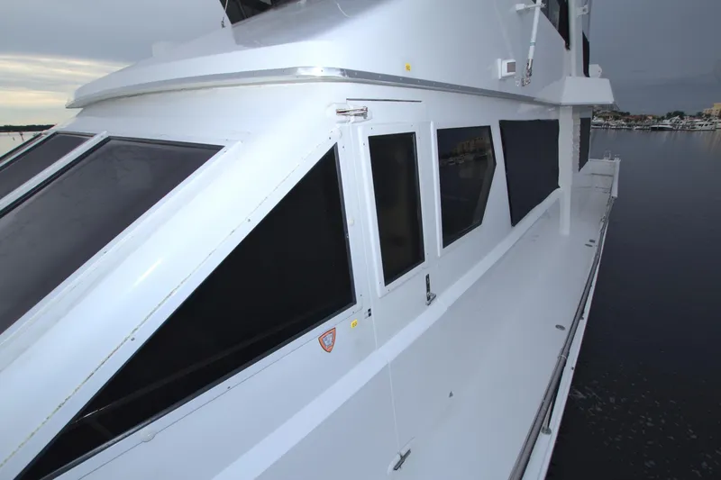 Slide: The Image of 1988 Viking 63 Cockpit Motor Yacht exterior view on the water. - 29