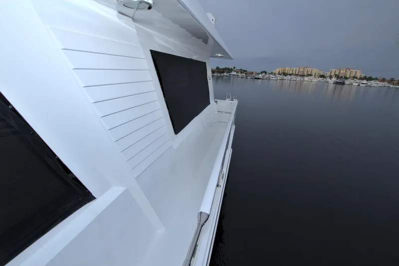 Slide: The Image of 1988 Viking 63 Cockpit Motor Yacht side deck with marina view. - 30