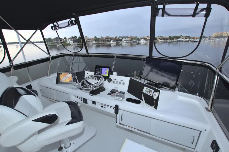 Slide: The Image of 1988 Viking 63 Cockpit Motor Yacht helm with modern navigation equipment. - 33