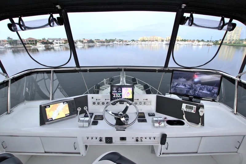 Slide: The Image of Cockpit view of 1988 Viking 63 Cockpit Motor Yacht with modern navigation equipment. - 34
