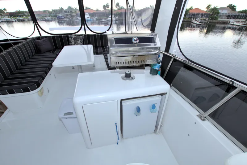 Slide: The Image of 1988 Viking 63 Cockpit Motor Yacht interior with seating and grill. - 36