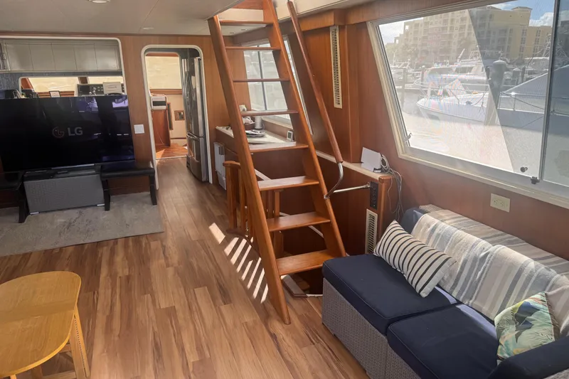 Slide: The Image of Interior of 1988 Viking 63 Cockpit Motor Yacht with cozy seating and wooden accents. - 39