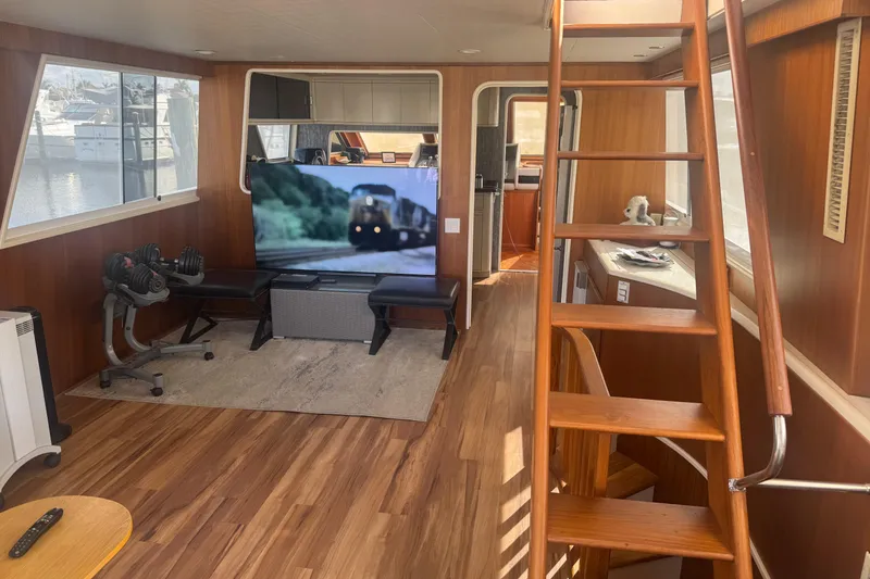 Slide: The Image of Interior of 1988 Viking 63 Cockpit Motor Yacht with wooden flooring and modern amenities. - 40