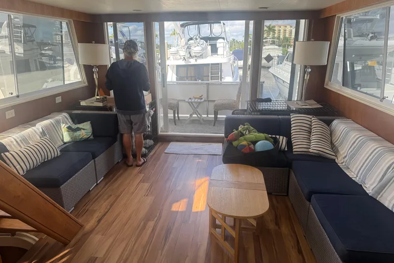 Slide: The Image of Interior of 1988 Viking 63 Cockpit Motor Yacht with cozy seating and wooden flooring. - 41
