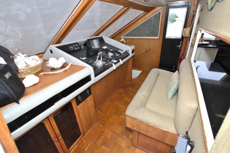 Slide: The Image of 1988 Viking 63 Cockpit Motor Yacht interior with helm, seating, and navigation equipment. - 46