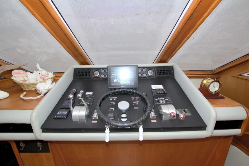 Slide: The Image of 1988 Viking 63 Cockpit Motor Yacht helm with navigation controls and steering wheel. - 47