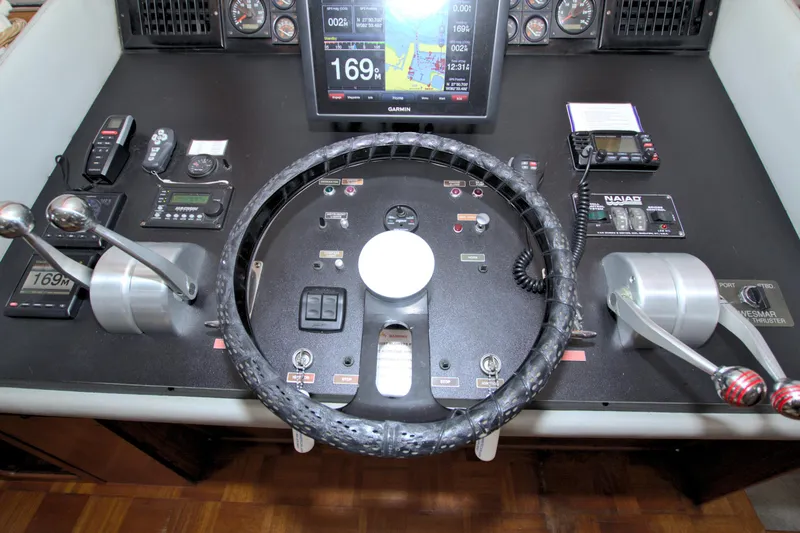 Slide: The Image of Control panel of 1988 Viking 63 Cockpit Motor Yacht with steering wheel and navigation instruments. - 49