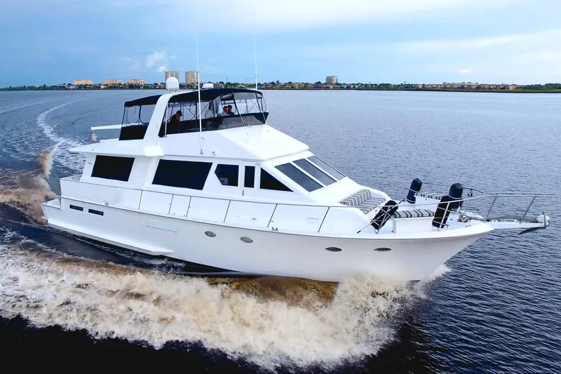 Slide: The Image of 1988 Viking 63 Cockpit Motor Yacht cruising on open water, showcasing sleek design and luxury. - 6