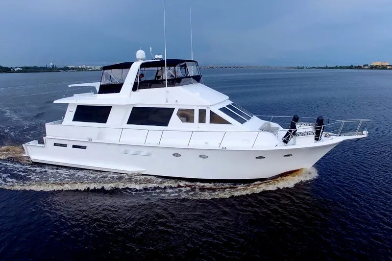 Slide: The Image of 1988 Viking 63 Cockpit Motor Yacht cruising on calm waters. - 7