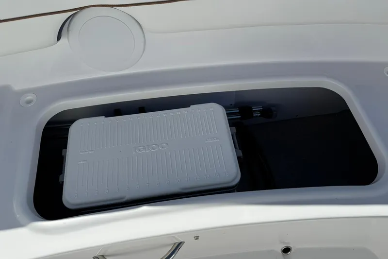 Slide: The Image of Storage compartment with Igloo cooler in 2026 Stingray 182 SC boat. - 13