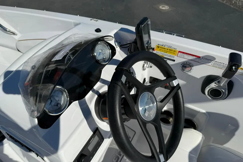 Slide: The Image of 2026 Stingray 182 SC boat dashboard with steering wheel and gauges. - 15