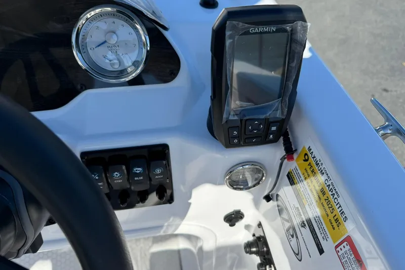 Slide: The Image of Dashboard of 2026 Stingray 182 SC boat with Garmin GPS and control switches. - 16
