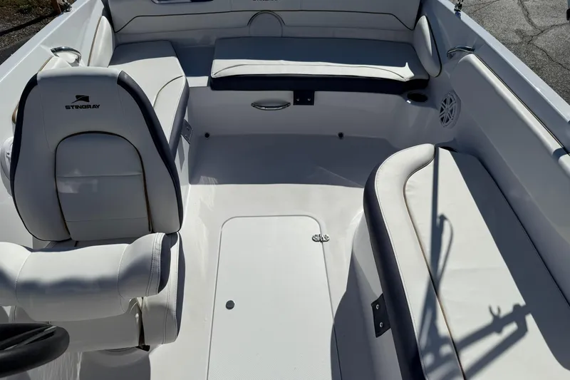 Slide: The Image of Interior of 2026 Stingray 182 SC boat with white seating and sleek design. - 19