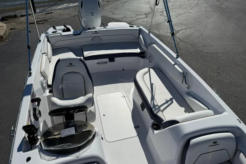 Slide: The Image of 2026 Stingray 182 SC boat interior with white seating and steering wheel. - 22