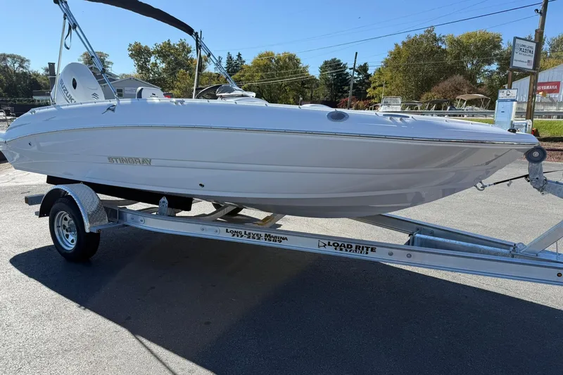 Slide: The Image of 2026 Stingray 182 SC boat on trailer, parked outdoors, sunny day. - 6