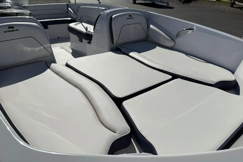 Slide: The Image of 2026 Stingray 182 SC boat interior with cushioned seating and sleek design. - 7