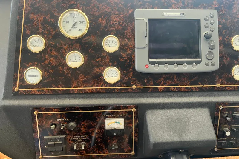 Slide: The Image of Pilothouse control panel of a 1986 Bayliner 4550 Motoryacht with gauges and navigation equipment. - 16