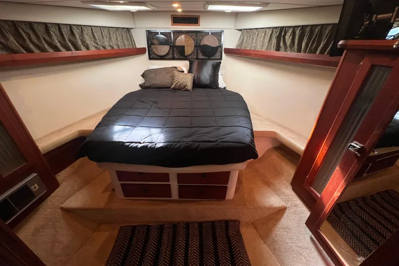 Slide: The Image of Luxurious cabin interior of 1986 Bayliner 4550 Motoryacht with cozy bed and elegant wood accents. - 20