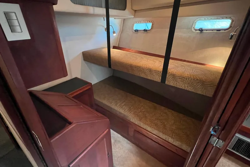 Slide: The Image of Interior cabin of 1986 Bayliner 4550 Motoryacht with bunk beds and porthole windows. - 23