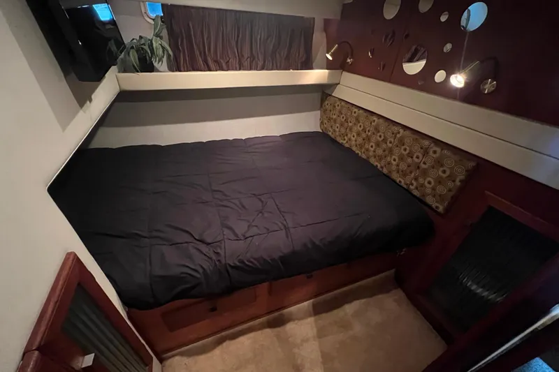 Slide: The Image of Cozy guest bedroom in 1986 Bayliner 4550 Motoryacht with modern decor and comfortable bedding. - 24