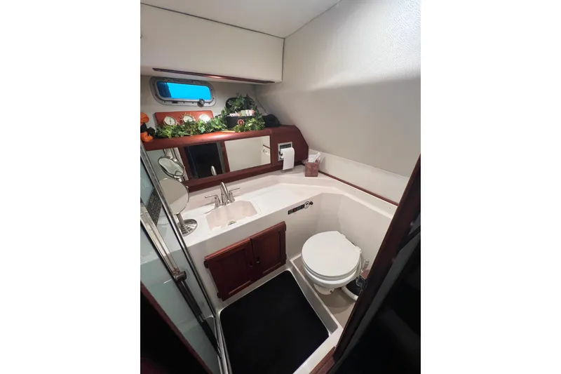 Slide: The Image of Luxurious guest bathroom in 1986 Bayliner 4550 Motoryacht with sink, toilet, and mirror. - 25
