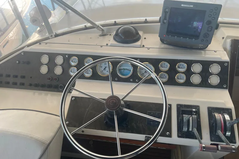 Slide: The Image of Flybridge helm with steering wheel, gauges, and navigation equipment. - 6