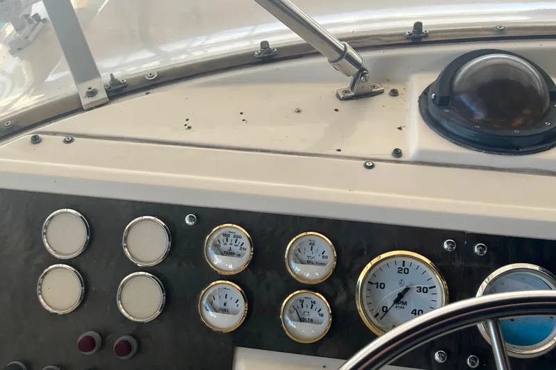 Slide: The Image of Dashboard of a 1986 Bayliner 4550 Motoryacht with gauges and steering wheel. - 8