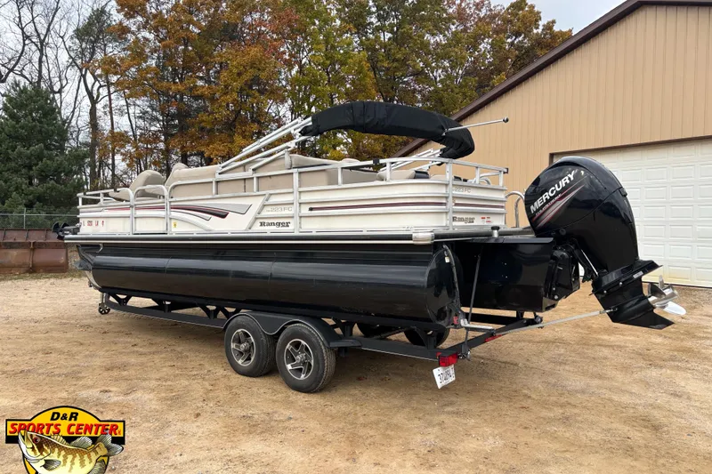 Slide: The Image of 2021 Ranger 223FC pontoon boat with Mercury engine on trailer, autumn trees background. - 2