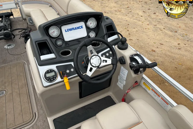 Slide: The Image of 2021 Ranger 223FC boat dashboard with steering wheel and Lowrance display. - 5