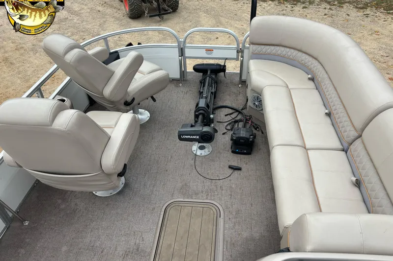 Slide: The Image of 2021 Ranger 223FC boat interior with beige seating and fishing equipment. - 6