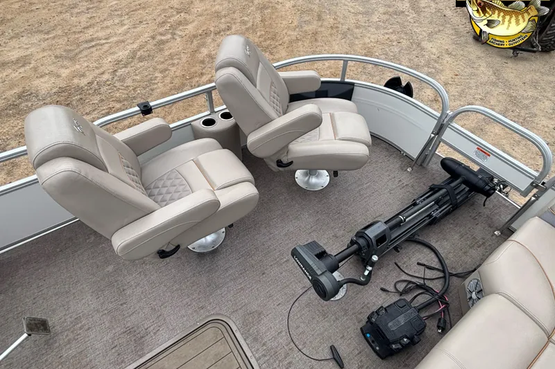 Slide: The Image of 2021 Ranger 223FC boat interior with beige seats and trolling motor. - 7