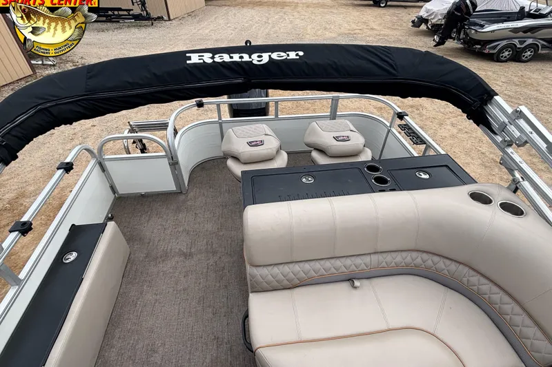 Slide: The Image of 2021 Ranger 223FC boat interior with seating and fishing setup, displayed outdoors. - 8