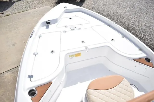 Slide: The Image of 2025 NauticStar 194 Bay boat deck with storage compartments and tan seating. - 6