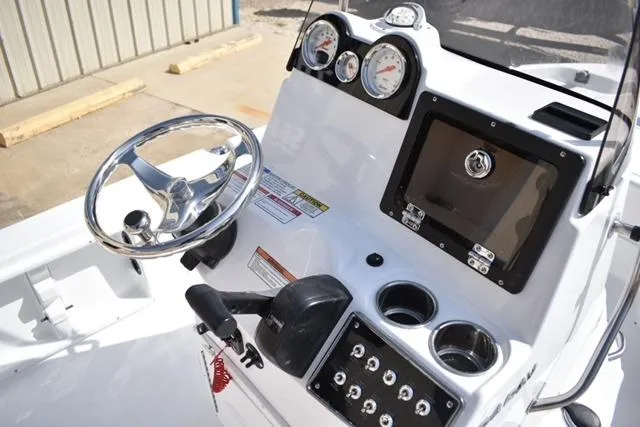 Slide: The Image of 2025 NauticStar 194 Bay boat dashboard with steering wheel, gauges, and control panel. - 7