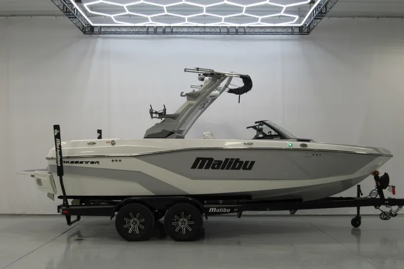 The Image of 2026 Malibu Wakesetter 21 LX boat on trailer in showroom. - 0
