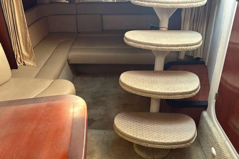 Slide: The Image of Interior of 2006 Sea Ray 340 Sundancer with beige seating and spiral staircase. - 10