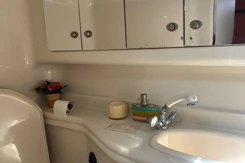 Slide: The Image of Bathroom interior of 2006 Sea Ray 340 Sundancer with sink, mirror, and decor. - 11