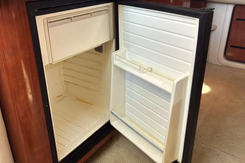 Slide: The Image of Open refrigerator inside a 2006 Sea Ray 340 Sundancer boat cabin. - 12